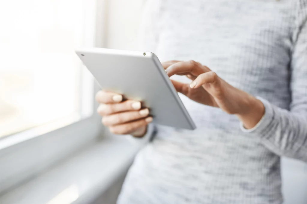 women holds a tablet
