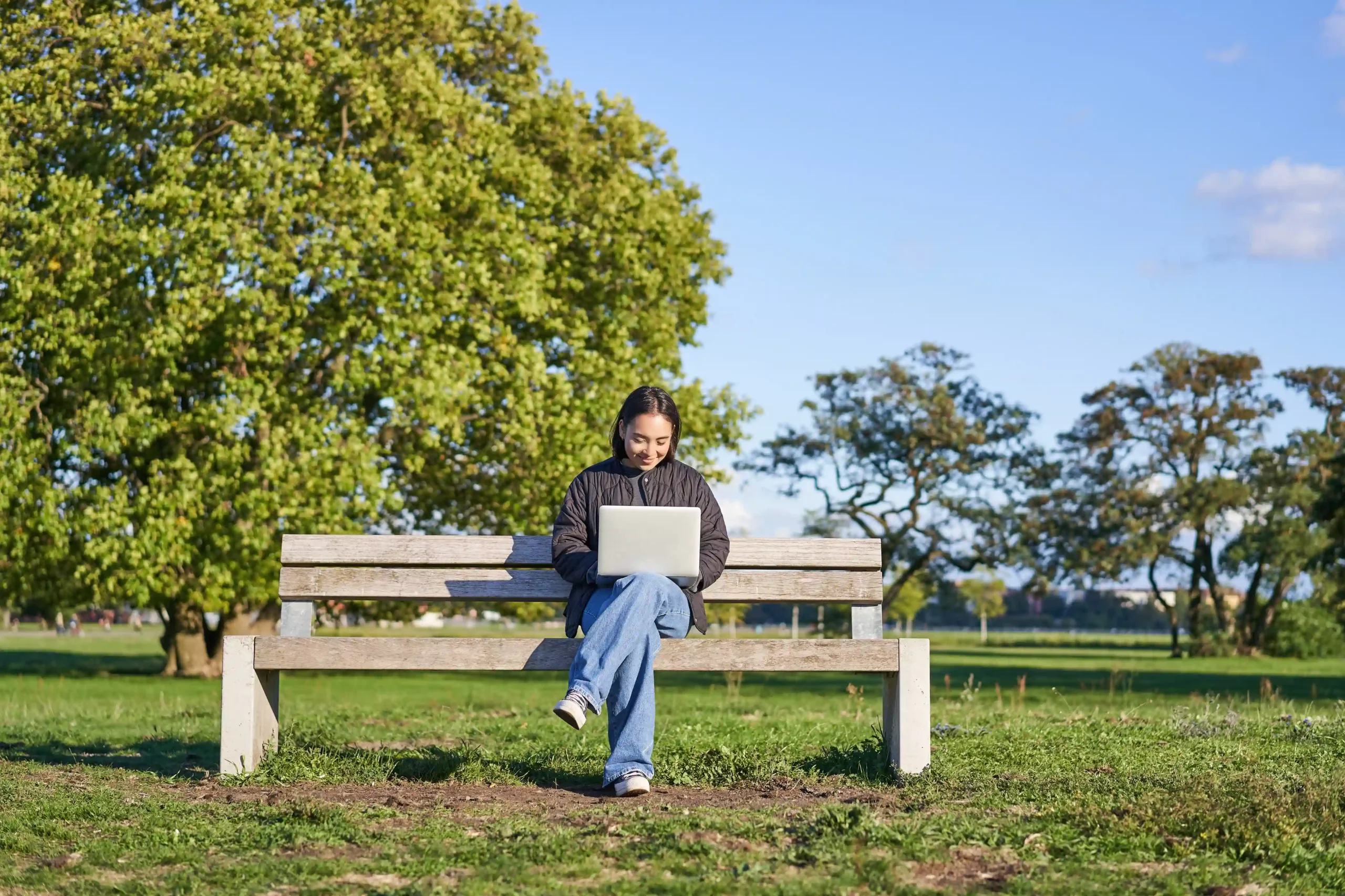 young woman working opendoor with pc